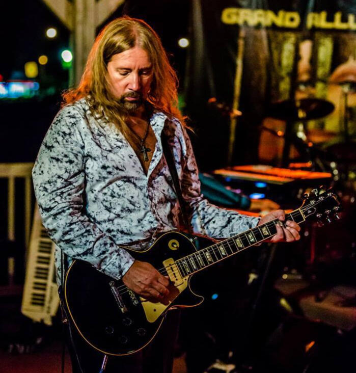 A picture of your teacher playing an electric guitar